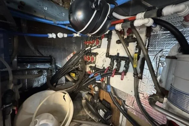 Slide: The Image of Engine room of a 1977 Californian 38 Motor Yacht with complex piping and wiring. - 23