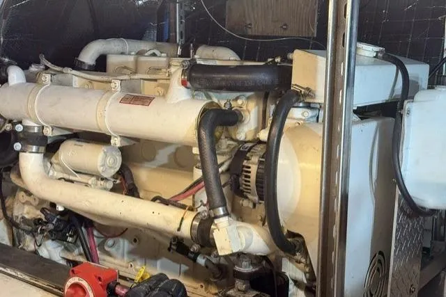 Slide: The Image of Engine room of a 1977 Californian 38 Motor Yacht, showcasing mechanical components. - 29