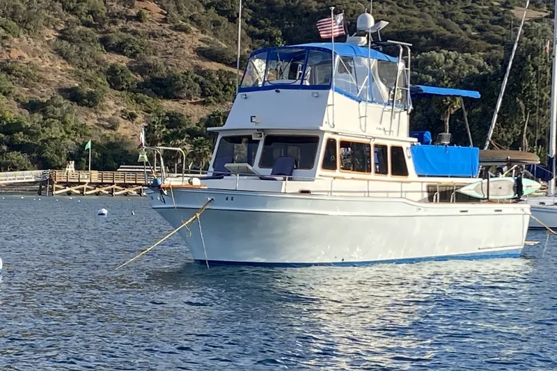 The Image of 1977 Californian 38 Motor Yacht anchored in scenic coastal waters. - 0