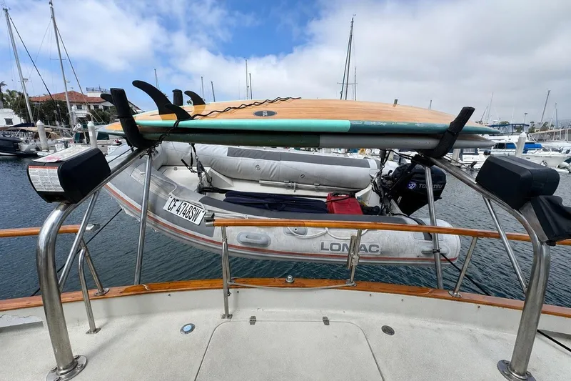 Slide: The Image of 1977 Californian 38 Motor Yacht with surfboard and inflatable boat in marina. - 39