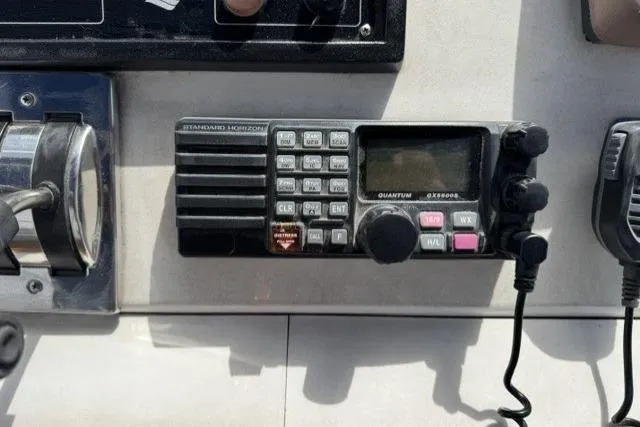 Slide: The Image of Radio equipment on 1977 Californian 38 Motor Yacht dashboard, featuring control knobs and microphone. - 50