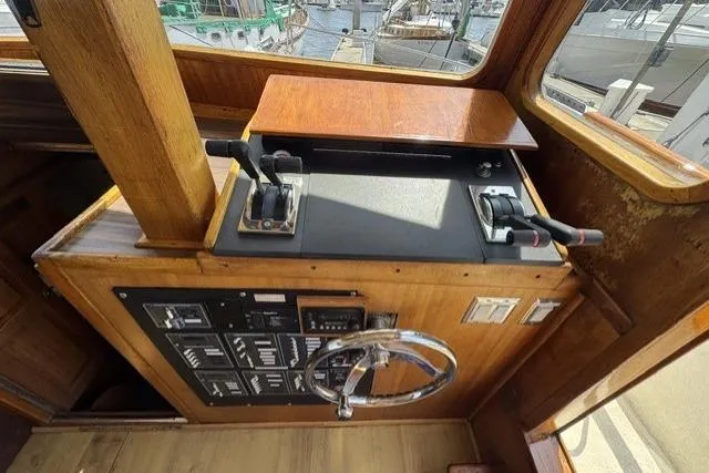 Slide: The Image of 1977 Californian 38 Motor Yacht helm with controls and steering wheel, showcasing classic wooden design. - 6
