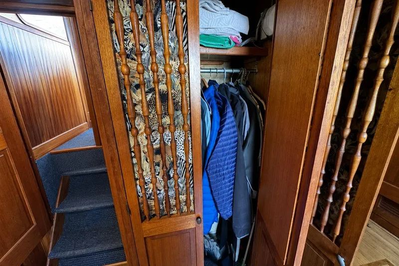 Slide: The Image of Wooden closet with clothes inside a 1977 Californian 38 Motor Yacht. - 37