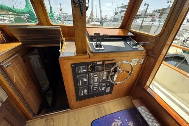 Slide: The Image of 1977 Californian 38 Motor Yacht helm with control panel and steering wheel. - 4