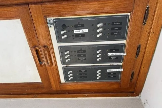 Slide: The Image of Control panel on a 1977 Californian 38 Motor Yacht with wooden cabinetry. - 47