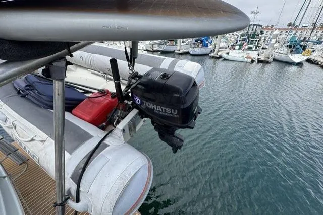 Slide: The Image of 1977 Californian 38 Motor Yacht with Tohatsu outboard motor and inflatable dinghy at marina. - 40