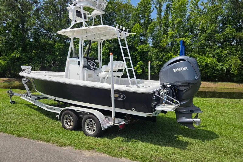 Slide: The Image of 2015 Sea Hunt BX 22 BR boat with Yamaha engine on trailer, parked on grass. - 2