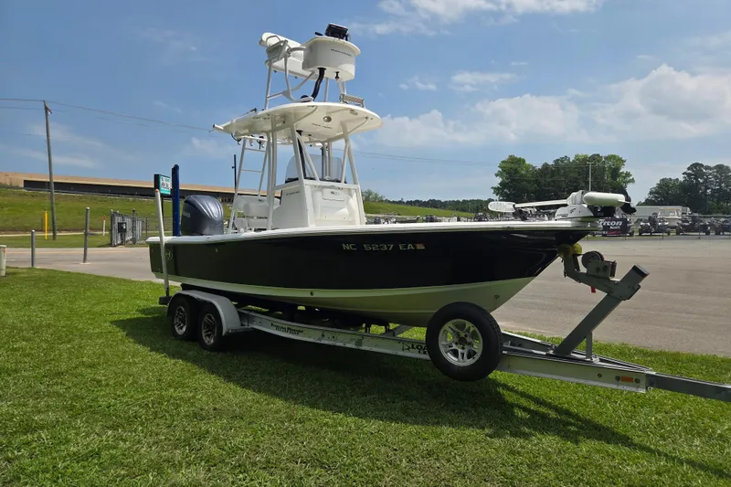 Slide: The Image of 2015 Sea Hunt BX 22 BR boat on trailer, parked on grass under a clear sky. - 7
