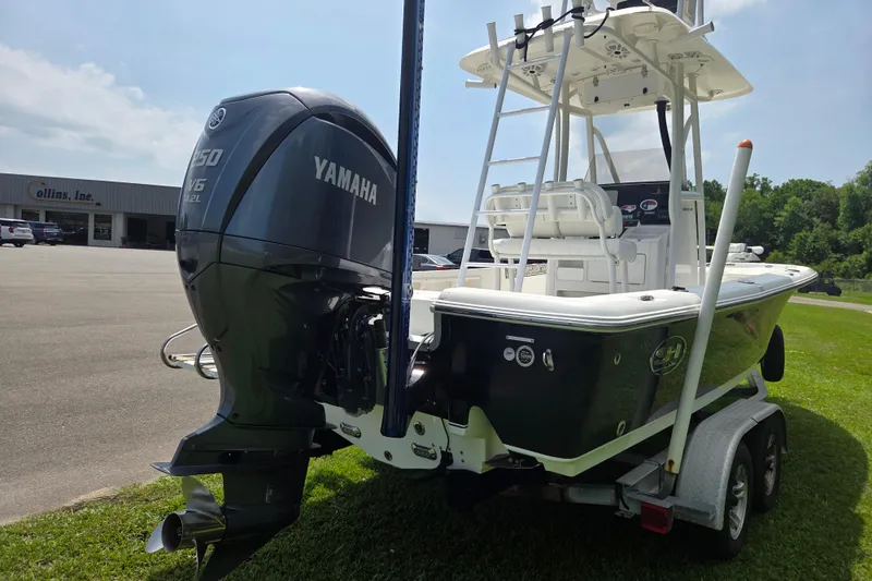 Slide: The Image of 2015 Sea Hunt BX 22 BR boat with Yamaha V6 engine on trailer, parked outdoors. - 4