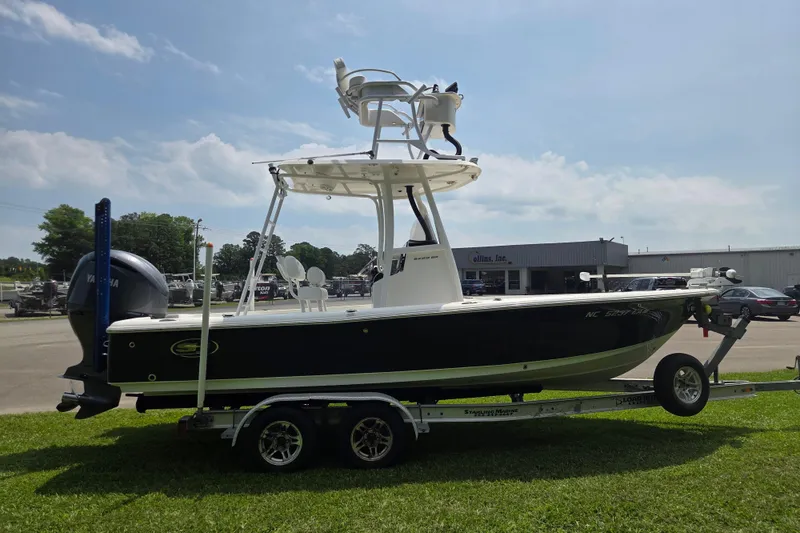 Slide: The Image of 2015 Sea Hunt BX 22 BR boat on trailer, parked outdoors under a clear sky. - 6