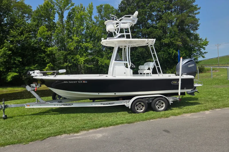 The Image of 2015 Sea Hunt BX 22 BR boat on trailer, parked on grass. - 0