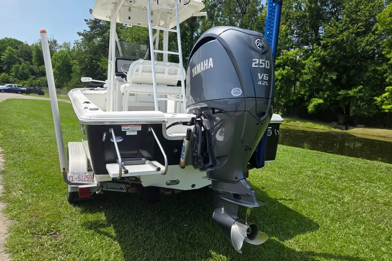 Slide: The Image of 2015 Sea Hunt BX 22 BR boat with Yamaha 250 V6 engine on grassy area. - 3