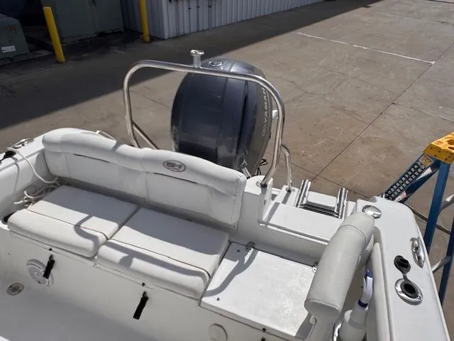 Slide: The Image of The image shows the stern of a 2018 Sea Hunt 234 SXS boat with an outboard motor. - 14