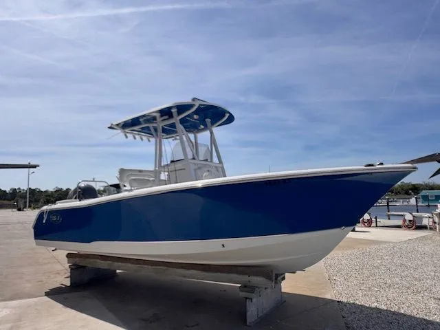 Slide: The Image of A blue and white boat on a dry dock, featuring a covered helm station. - 11