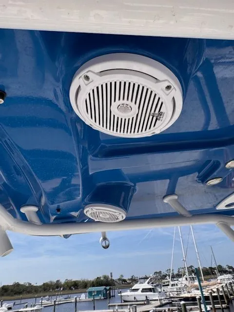 Slide: The Image of View of a boat's blue roof with speakers and lights, harbor in the background. - 22