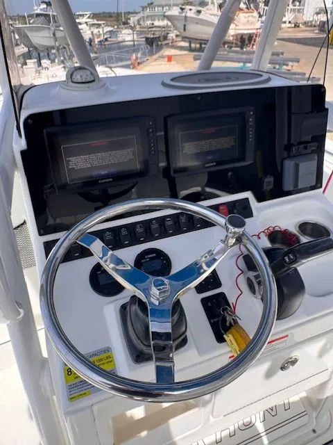 Slide: The Image of The image shows the helm of a Sea Hunt 234 SXS boat with two screens and controls. - 27
