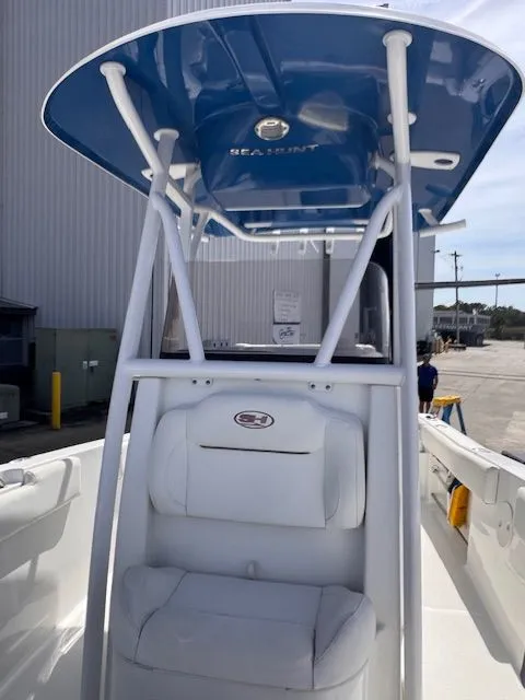 Slide: The Image of The image shows the cockpit of a Sea Hunt 234 SXS boat with a blue T-top. - 16