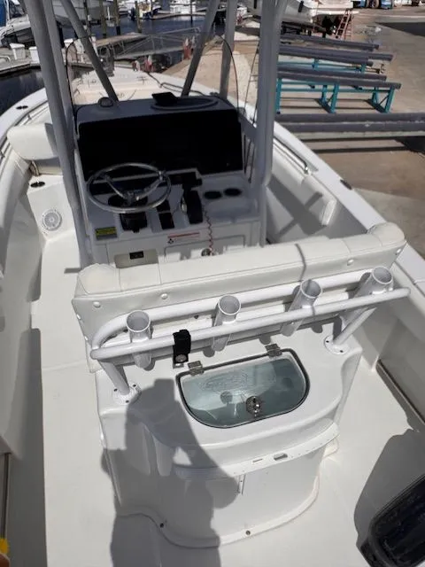 Slide: The Image of The image shows the cockpit of a 2018 Sea Hunt 234 SXS boat with white interior. - 13