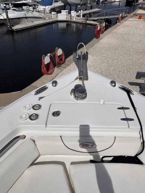 Slide: The Image of The image shows the bow of a Sea Hunt 234 SXS boat at a marina. - 15