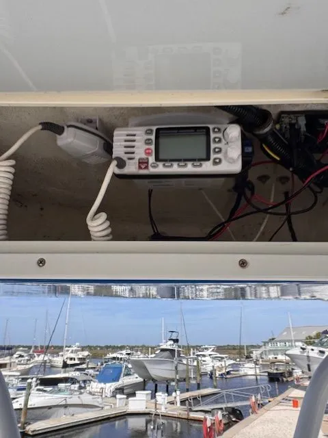 Slide: The Image of A radio is mounted inside a boat, with a marina in the background. - 24