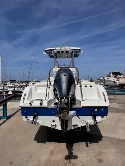 Slide: The Image of A 2018 Sea Hunt 234 SXS boat on a trailer at the harbor. - 2