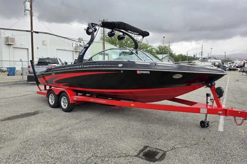 Slide: The Image of 2012 Centurion Enzo SV233 boat on red trailer in parking lot, overcast sky. - 7