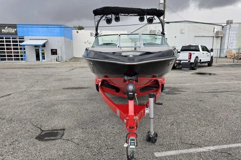 Slide: The Image of 2012 Centurion Enzo SV233 boat on red trailer in parking lot. - 4