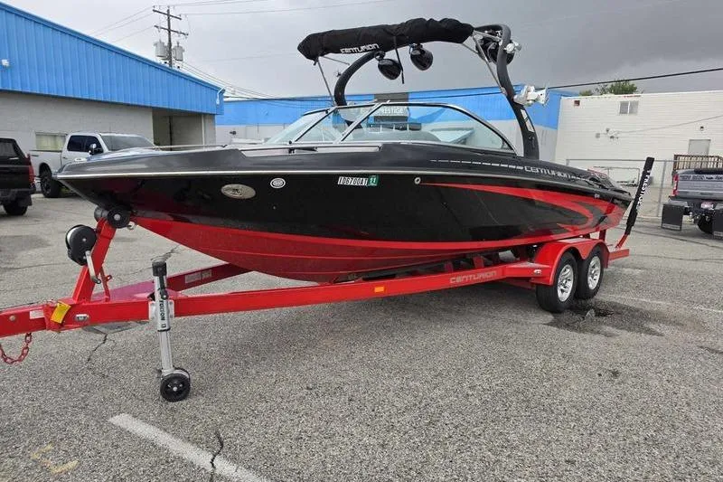 Slide: The Image of 2012 Centurion Enzo SV233 boat on red trailer in parking lot. - 2