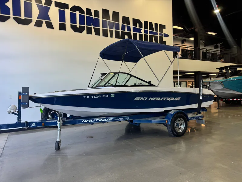 Slide: The Image of A 2010 Ski Nautique 200 boat on a trailer inside a showroom. - 3