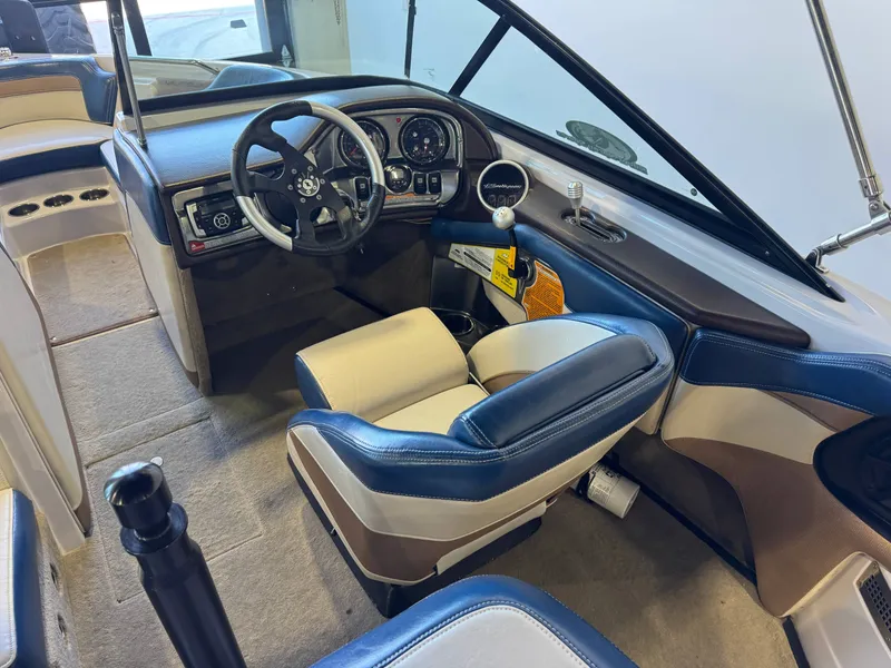Slide: The Image of Interior of a 2010 Nautique Ski Nautique 200 with blue and white seats and a modern dashboard. - 22