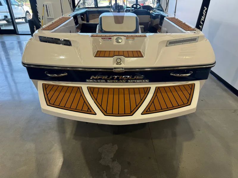 Slide: The Image of The image shows the stern of a 2010 Nautique Ski Nautique 200 boat with wood accents. - 8
