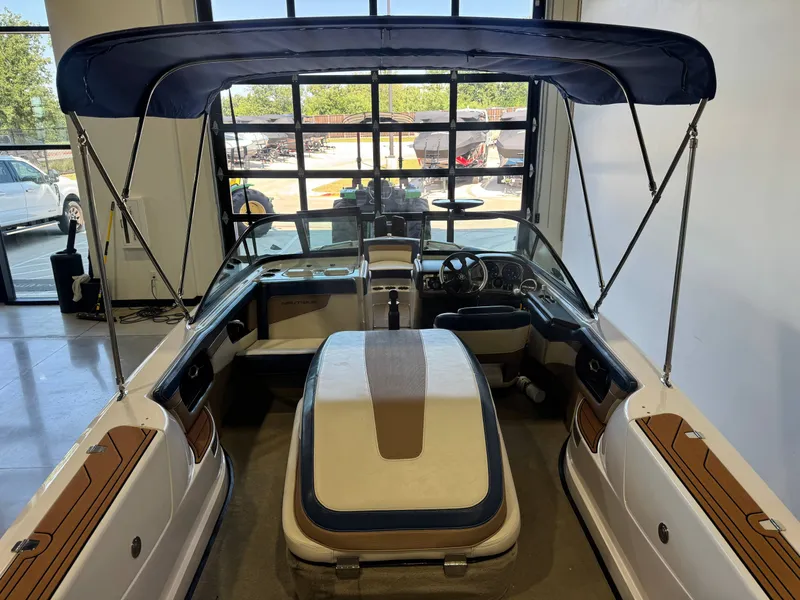Slide: The Image of Interior view of a 2010 Nautique Ski Nautique 200 with blue canopy and sleek seating. - 9