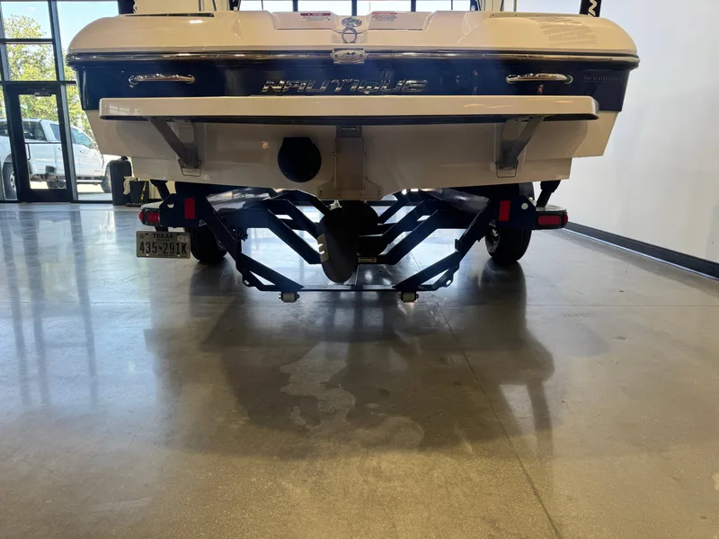 Slide: The Image of Rear view of a 2010 Ski Nautique 200 boat on a trailer in a showroom. - 7
