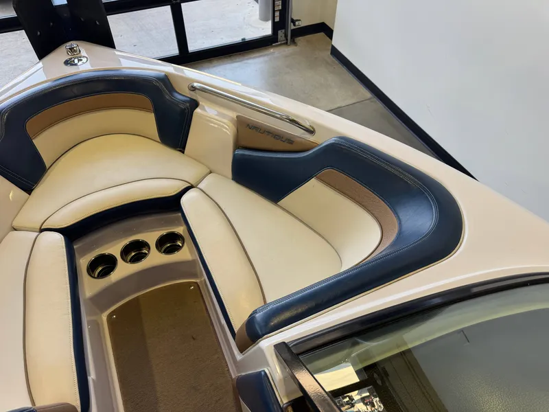 Slide: The Image of Interior view of a 2010 Nautique Ski Nautique 200 with beige and blue seating. - 16