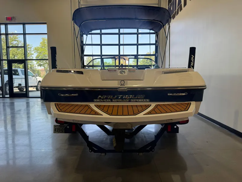 Slide: The Image of A 2010 Nautique Ski Nautique 200 boat on a trailer in a showroom. - 6