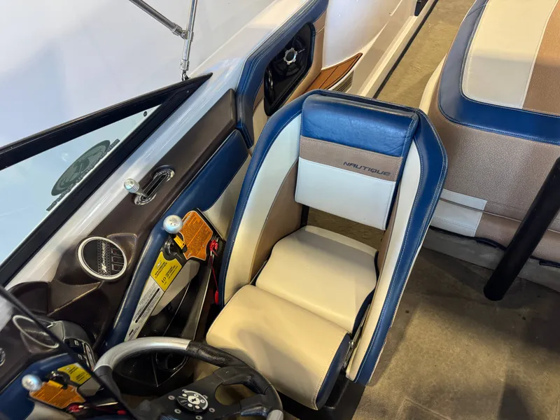 Slide: The Image of Interior view of a 2010 Nautique Ski Nautique 200 with beige and blue seating. - 19