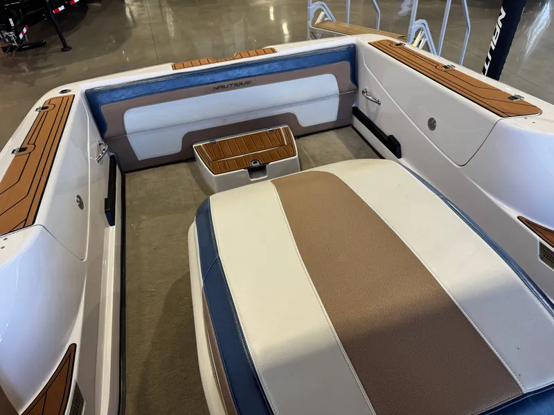 Slide: The Image of Interior of a 2010 Nautique Ski Nautique 200 with cushioned seating and teak accents. - 14