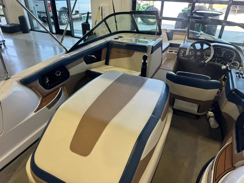 Slide: The Image of Interior view of a 2010 Nautique Ski Nautique 200 with beige and brown seating. - 11