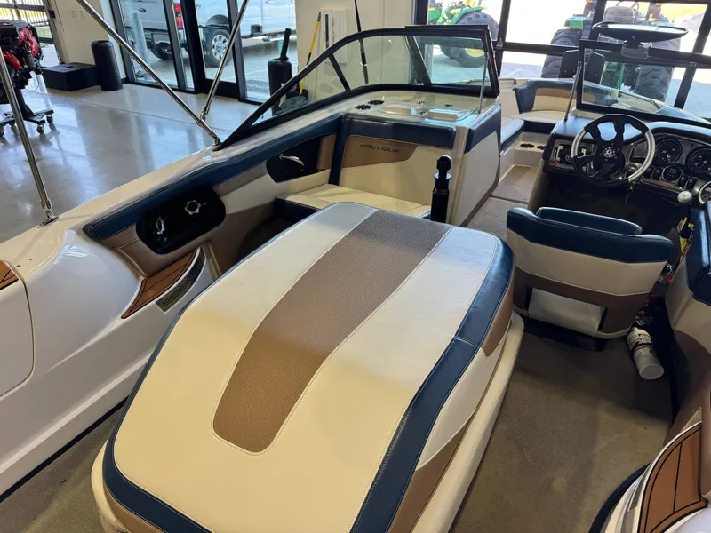 Slide: The Image of Interior view of a 2010 Nautique Ski Nautique 200 with beige and blue seating. - 12