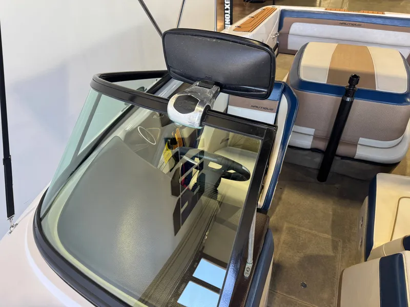 Slide: The Image of Interior view of a 2010 Nautique Ski Nautique 200 with blue and beige seating and steering wheel. - 18