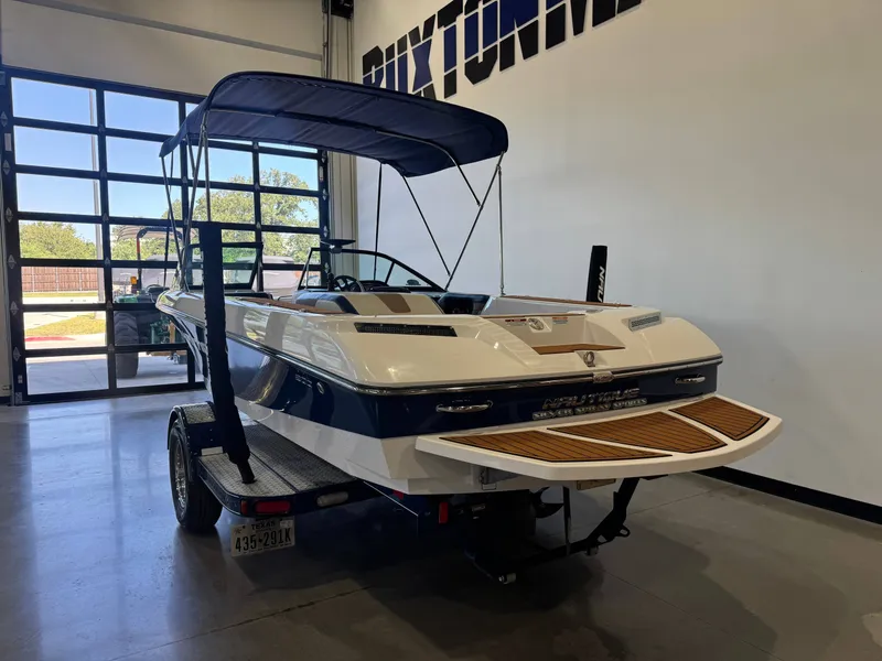 Slide: The Image of 2010 Nautique Ski Nautique 200 on a trailer inside a building. - 5