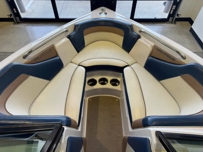 Slide: The Image of Interior view of the bow area of a 2010 Nautique Ski Nautique 200 with beige and blue seating. - 15