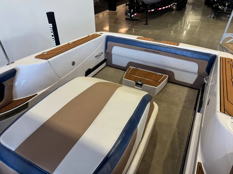 Slide: The Image of Interior of a 2010 Nautique Ski Nautique 200 with cushioned seating and wood accents. - 13
