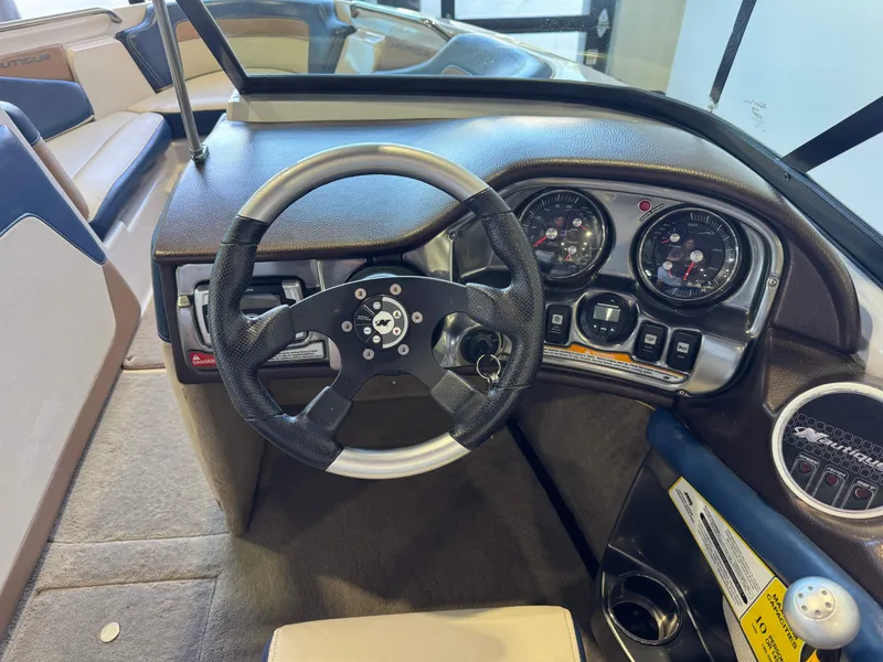 Slide: The Image of The image shows the cockpit of a 2010 Nautique Ski Nautique 200 with a modern steering wheel and instruments. - 24