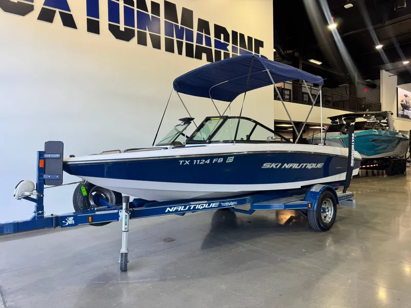 Slide: The Image of 2010 Nautique Ski Nautique 200 on a trailer in a showroom. - 2