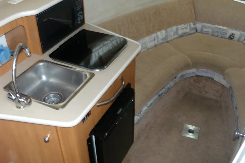 Slide: The Image of 2002 Bayliner 2455 Ciera interior with kitchenette and seating area. - 10