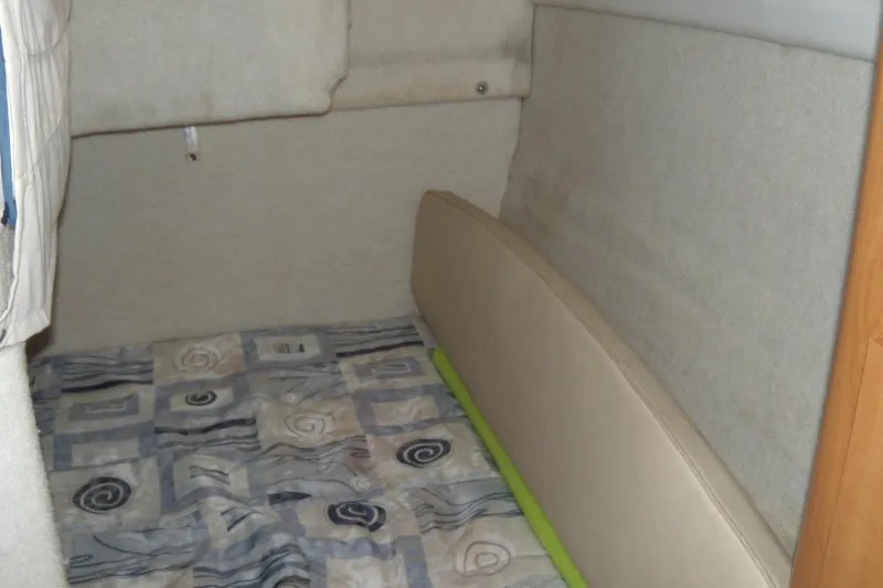 Slide: The Image of Interior cabin of 2002 Bayliner 2455 Ciera with patterned bedding. - 12