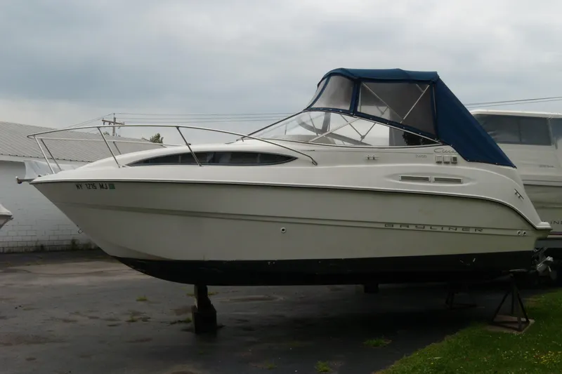 The Image of 2002 Bayliner 2455 Ciera boat with blue canopy on dry dock. - 0