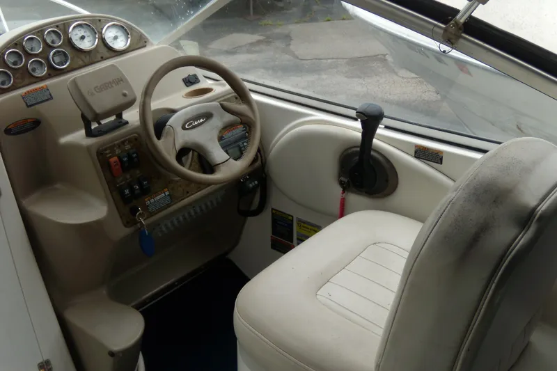 Slide: The Image of 2002 Bayliner 2455 Ciera boat cockpit with steering wheel and control panel. - 4