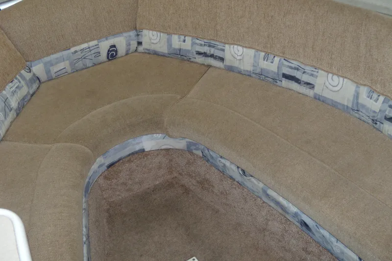 Slide: The Image of 2002 Bayliner 2455 Ciera interior seating with beige and patterned upholstery. - 11